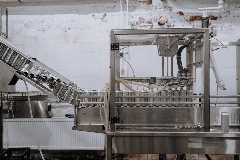 Automated beverage can packaging in a modern factory setting.